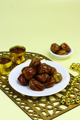 Sukkari Dates Fruits on isolated background. Breakfasting concept in Ramadan month. Islamic template for text background. 
