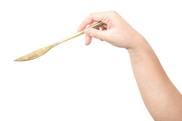 Female hand holding a golden steel cooking knife isolated on white background.