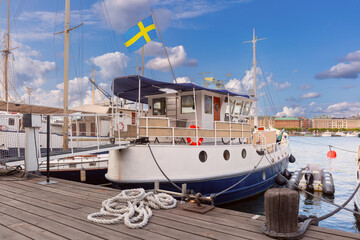 Old boats moored at the embankment in Stockholm, Sweden