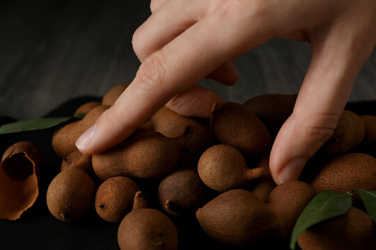 Ripe tamarind on a black board on a dark background