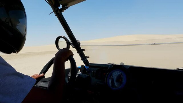 Pov from the driver's seat on atv quad drive in on safari in sahara desert landscape
