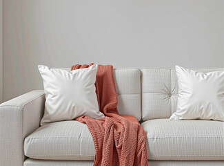 Simple and elegant mockup of a blank pillow on a modern sofa in a minimalist living room, ideal for showcasing branding or design elements.