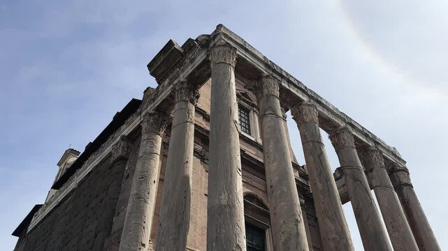Panoramic view of Temple of Antoninus and Faustina or church San Lorenzo Miranda in Roman Forum in Rome, Italy with large columns and a cross on top