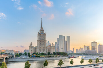 High-rise stalinist building near river at summer sunset in Moscow, Russia. Historic name is Hotel...