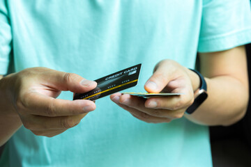 Man holding credit cards and he is choosing a credit card to pay and spend Payment for goods via credit card. Finance and banking concept	
