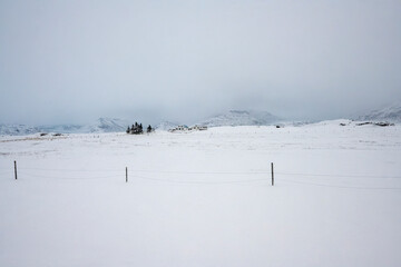 Landscape view of snow covered fields and mountain ranges in Iceland. Nature, travel, winter background, or wallpaper