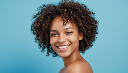 
 

Close up beautiful young african woman with curly hair smiling on blue background