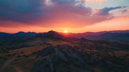 Fototapeta premium Majestic Sunset Over Rolling Hills and Mountains