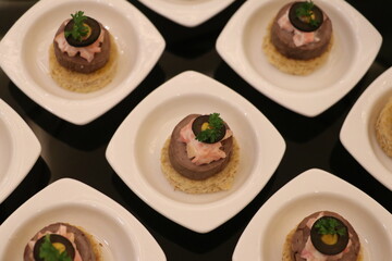 Elegant appetizer plates with garnish detail.
