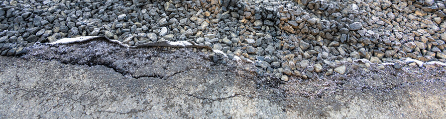 Gravel parking area on new construction lot, frosty and frozen tire tracks early on a winter morning
