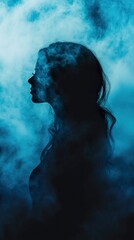 Fototapeta premium Mysterious Woman Silhouette in Blue Smoke: A Dreamlike Portrait
