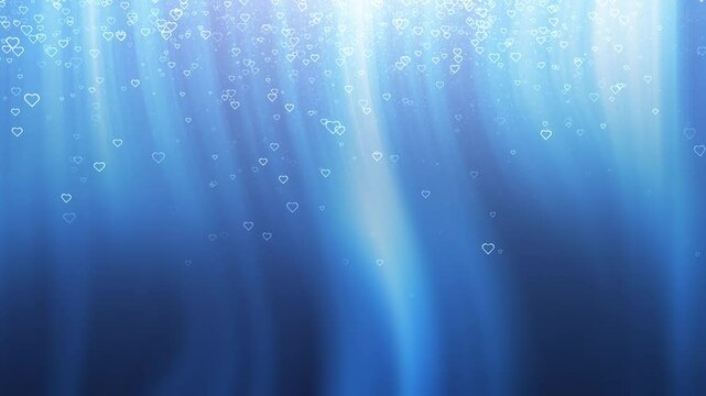 Abstract blurred blue background wit looping falling hearts backgrounds.