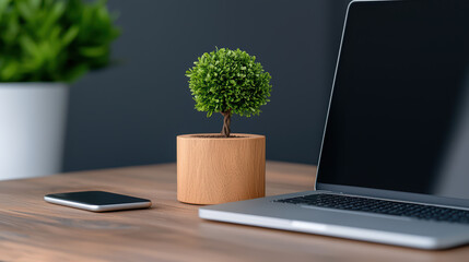 Fototapeta premium modern workspace featuring laptop, smartphone, and decorative plant