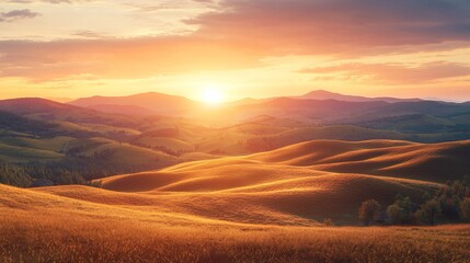 Obraz premium Golden sunset over rolling hills and mountains.