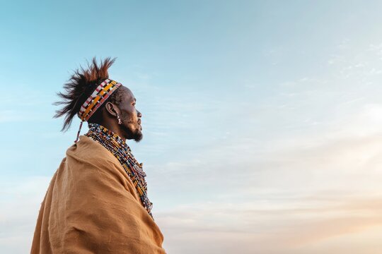A man in traditional Maasai attire adorned with colorful beads and patterns. He stands, Generative AI 