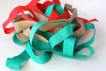 Lots of brightly colored straps. Flat webbing or cotton straps for sewing handles to bags.