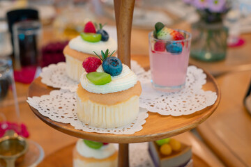 Cupcakes with friuits and other bakery snacks on a cake stand