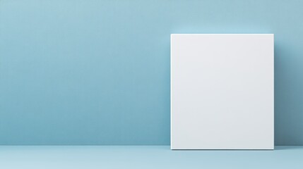 Naklejka premium A plain white poster is mounted on a blue wall, creating a simple yet striking visual contrast within a room's interior design.
