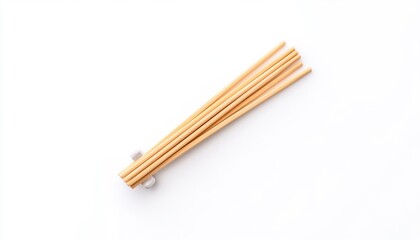 A set of bamboo chopsticks neatly arranged on a white background, ideal for culinary presentations and dining