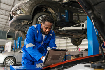 Team Auto mechanic are checking and repair maintenance auto engine is problems at car repair shop.