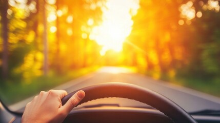 A driver confidently holds the steering wheel while driving on a scenic road illuminated by warm sunlight filtering through the trees