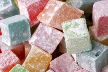 Colorful cube-shaped candies stacked in a delightful assortment for a sweet treat experience