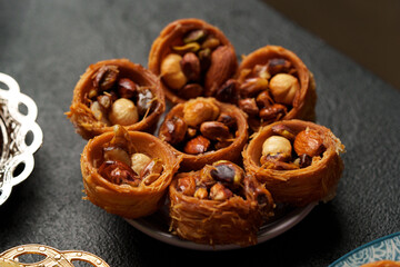 Delicious dessert featuring layered pastry filled with assorted nuts and caramelized sweetness in a beautifully crafted bowl