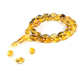 A yellow and brown rosary minaret amber with a white string