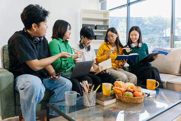 Learning online working concept. Asian college student working on tablet and laptop computer, searching knowledge in home.