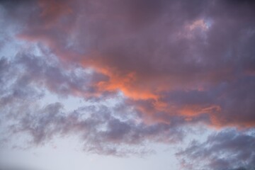 Beautiful sunset sky filled with colorful clouds over a peaceful landscape in the evening light