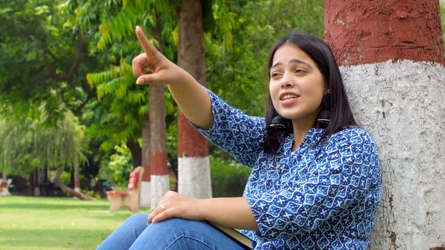Energetic Indian woman talking with friend on video call - virtual conversation  chatting with friend  gossiping . POV of tourist receiving directions - interacting with a talkative Asian girl  exc...