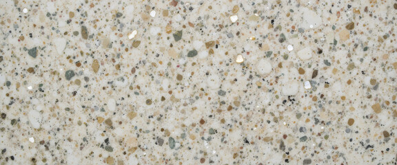 Fototapeta premium Close-up of a textured surface featuring various stones and aggregates.