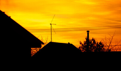 A house with a chimney and a satellite dish on top