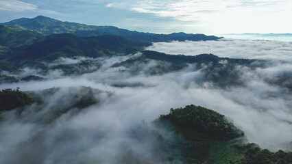 Aerial landscape view of the sea of fog flowing on hills by drone