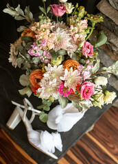 colourful wedding bouquet details with the bride's shoes