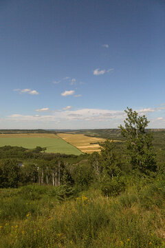 looking out at a landscape of rolling hills and farmer's fields