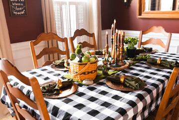 Dining room with wooden chairs, and festive spring centerpiece.
