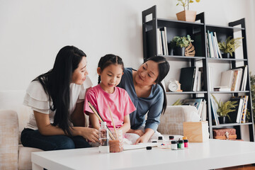 Couple creating family memories while adopting a child through art activity at home