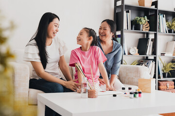 LGBTQ couple enjoying quality time with their adopted daughter while engaging in creative activities at home