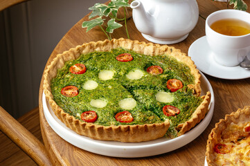 quiche with tomatoes and spinach on a plate