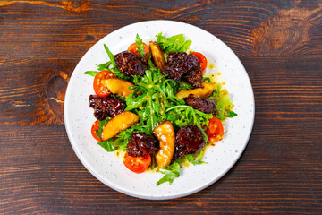 Delicious salad with mixed greens, grilled chicken, and fresh tomatoes Savory vegetable pie served with fresh garnishes on a white plate