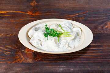 Creamy mushroom dish served on a wooden table with herbs Savory vegetable pie served with fresh garnishes on a white plate