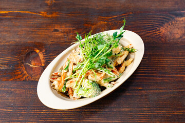 Delicious salad with fresh greens and creamy dressing served in a bowl Savory vegetable pie served with fresh garnishes on a white plate