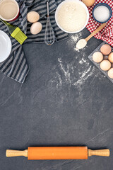 Baking background. Ingredients for baking cakes. Eggs, flour and rolling pin.