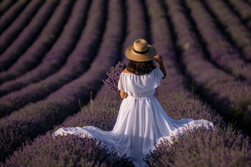 Lavender Fields Provence Woman: Summer photoshoot; woman in white dress admires purple lavender...