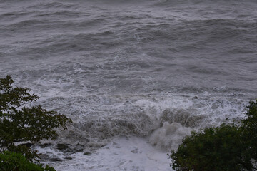 Around, Giola Natural Swimming Pool, Vagues, Sea coast in the foreground, in the background the sea in rainy weather, high sea waves, Ocean storm weather with huge waves