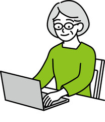 パソコンに向かう年配の女性　黄緑