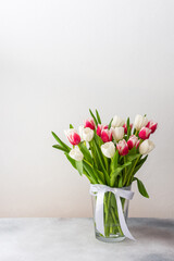 Beautiful spring bouquet of pink and white tulips in a glass vase, birthday or March 8th or mother's day concept