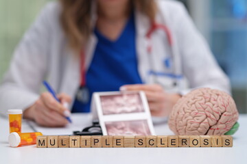 A healthcare professional is carefully analyzing medical images that are related to multiple sclerosis and its effects