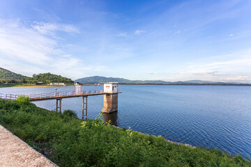 Landscape shot of a calm river and bright summer sky at a reservoir in a park